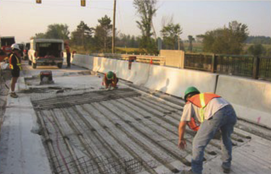FIGURE 3 Installing distributed galvanic anodes and carbon fiber grid prior to installing concrete overlay.