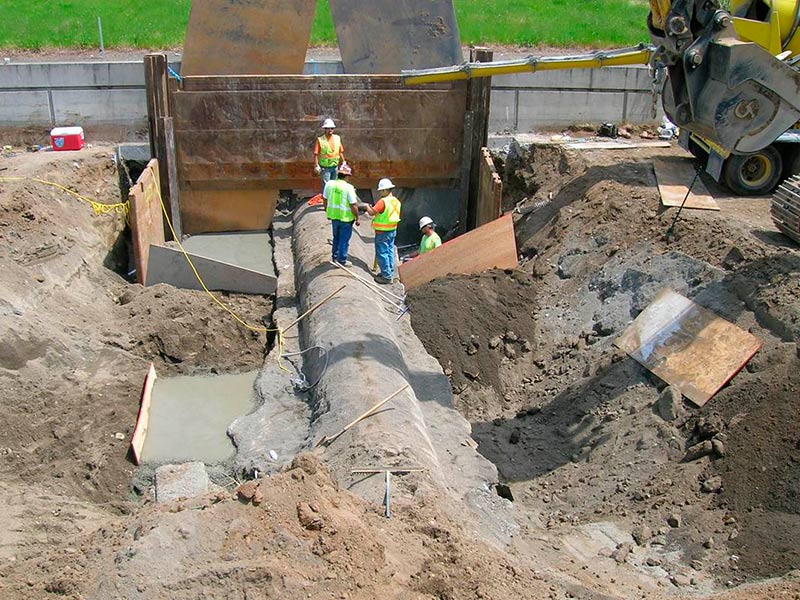 The water pipes were excavated at 10-ft spans and concrete support saddles were cast in place. Image courtesy of Stuart Greenberger.