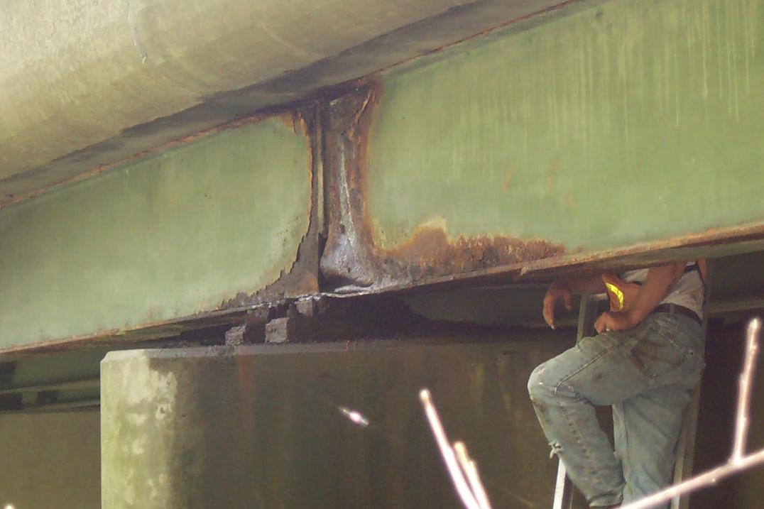 A bridge, showing corrosion of a steel beam. Photo courtesy of CME Engineering and UConn