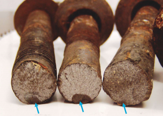 FIGURE 3 Environmental cracking of rock bolts. The arrows show the initial subcritical crack.