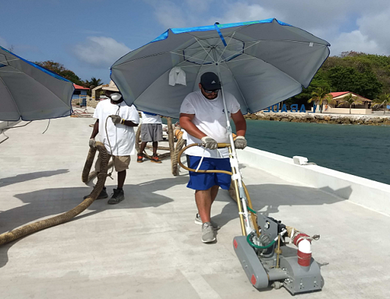 Crew members prepped ~4,000 ft² (372 m²) per day on the pier. Breaks were regularly taken due to extreme heat. Photo courtesy of DESCO Manufacturing.