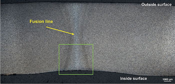 FIGURE 6 shows a photo-macrograph of the mounted cross-section at the intact weld. 