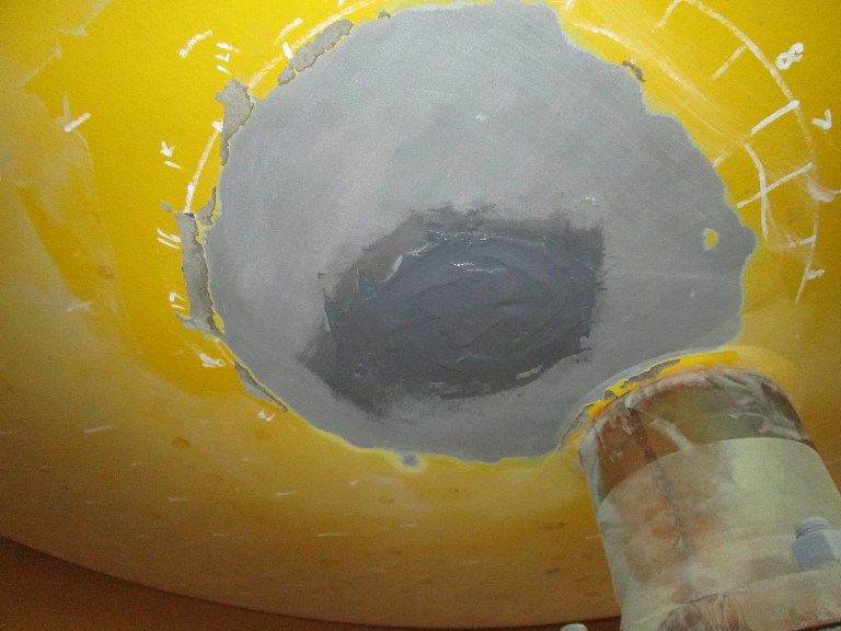A two-part surface tolerant epoxy composite healed thin and through-wall defects.